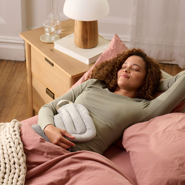 holding hot water bottle on stomach