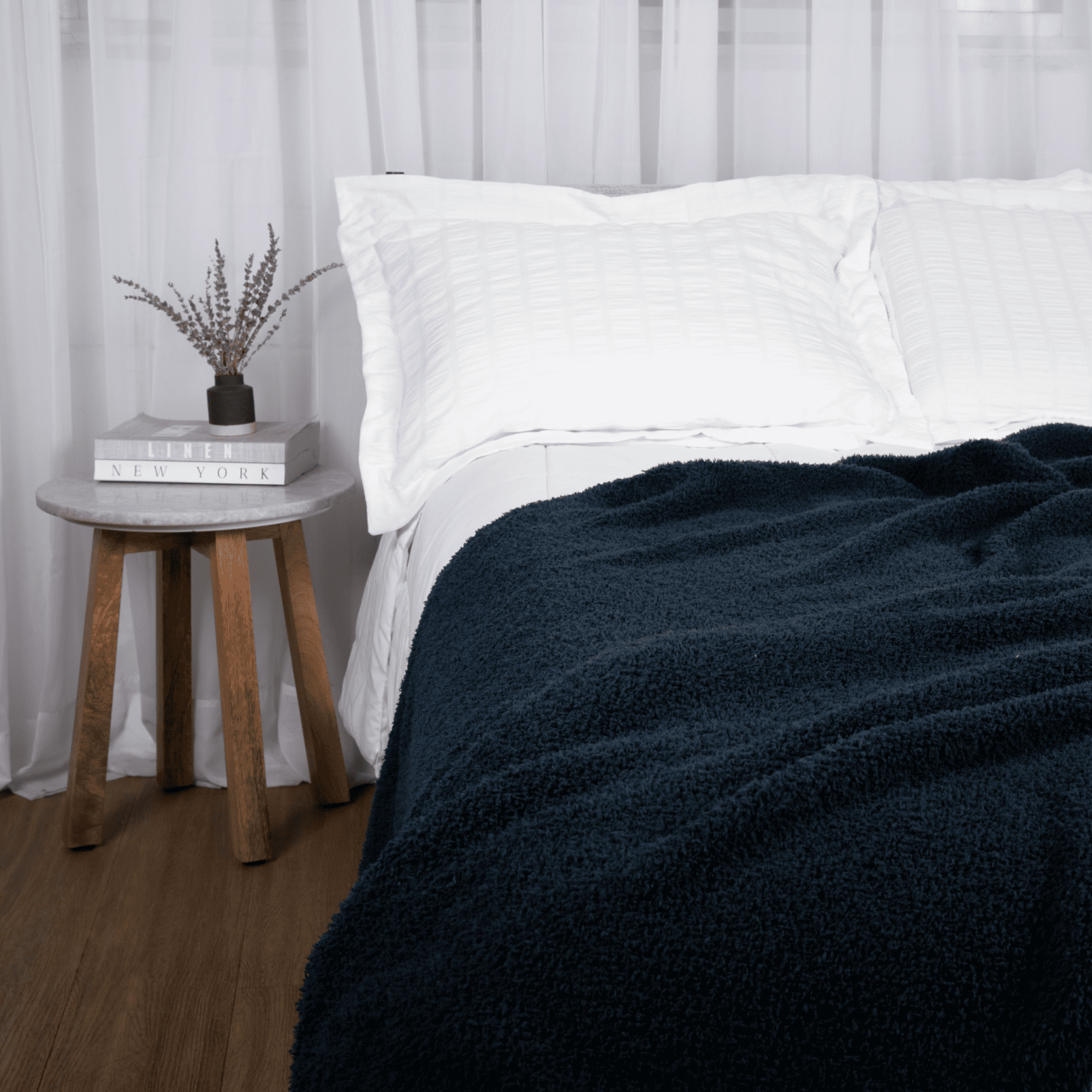 bearaby muslin blanket on bed