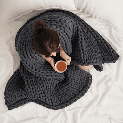 women wrapped in bearaby grey blanket