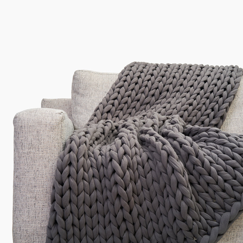 Grey chunky weighted blanket on sofa