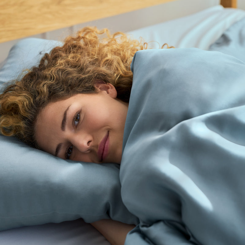 women with blue bamboo sheet plus duvet cover