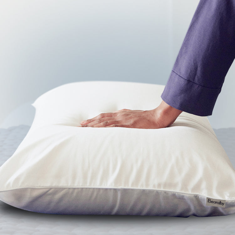 bearaby softform pillow with a women hand on top of it
