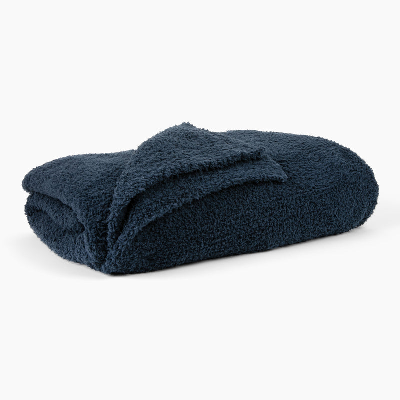 folded blue plush blanket