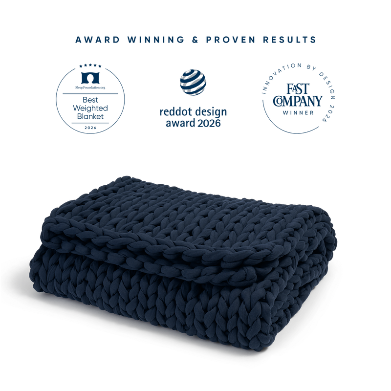 bearaby midnight blue folded weighted blanket with three publication awards 