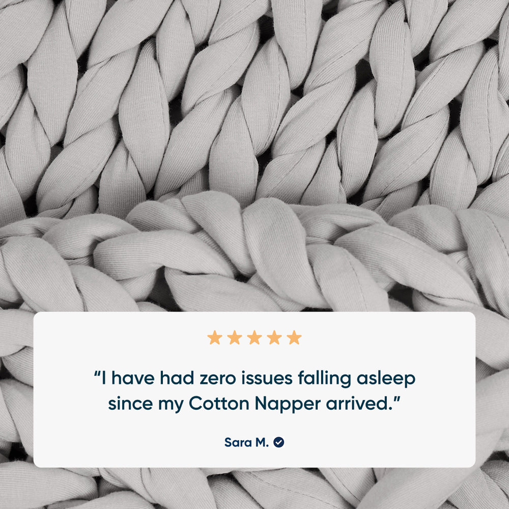 Text review of a product with braided cotton weighted blanket in the background