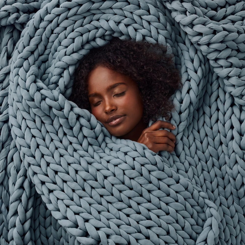 Blue spruce weighted blanket wrapped by a beautiful lady