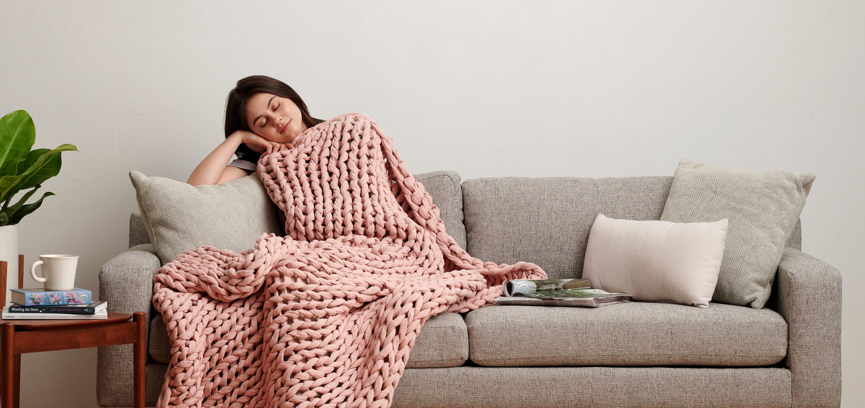 Woman relaxing under a weighted blanket